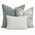 The Abstract Southwest Trio Throw Pillow Bundle by Hillcroft Home features three decorative pillows—a solid sage green pillow, an abstract blue and tan floral patterned pillow, and a rectangular light beige plaid pillow—arranged together on a white background.