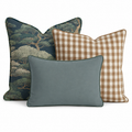 The Hillcroft Home Cypress Grove Trio Throw Pillow Bundle features three decorative pillows—one adorned with a tree pattern, one in a brown and white gingham check, and one in a solid light blue—arranged overlapping against a white background.