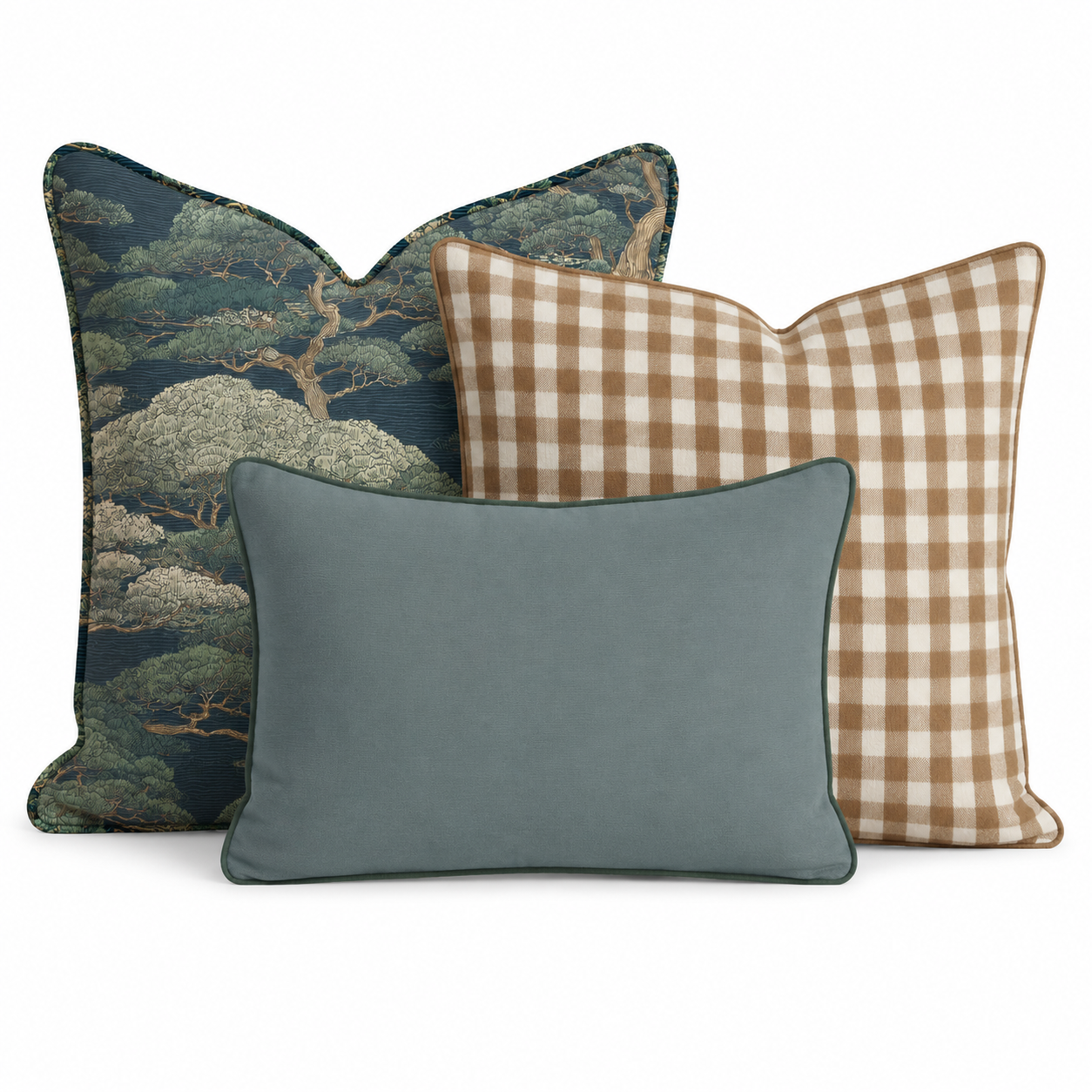 The Hillcroft Home Cypress Grove Trio Throw Pillow Bundle features three decorative pillows—one adorned with a tree pattern, one in a brown and white gingham check, and one in a solid light blue—arranged overlapping against a white background.